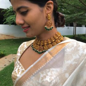 Premium Gold Alike Lakshmi Neckpiece Set adorned with Kemp Stones
