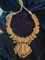 Antique Premium Gold Necklace Adorned with Lakshmi Goddess, White and Red Kemp Stones