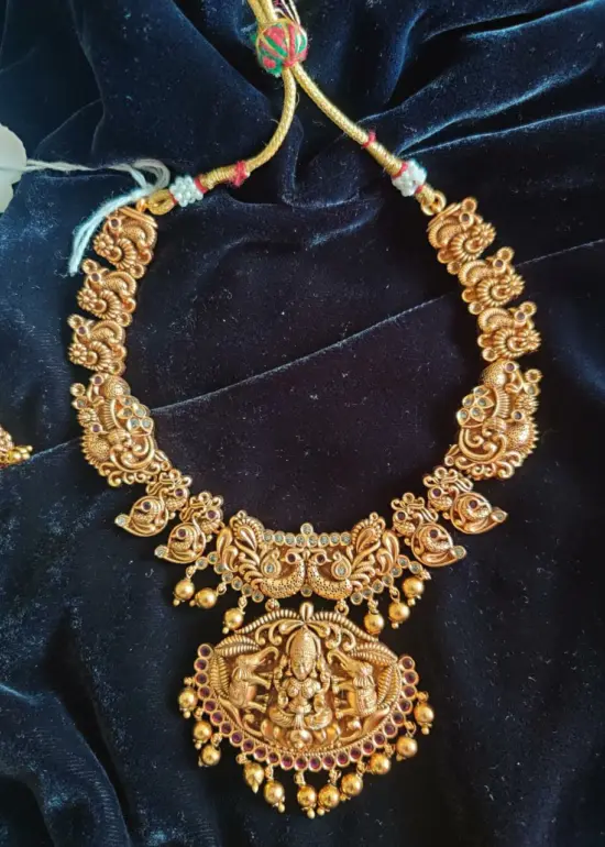 Antique Premium Gold Necklace Adorned with Lakshmi Goddess, White and Red Kemp Stones
