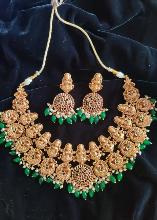 Premium Exclusive Gold Bridal Necklace Adorned with Lakshmi Goddess, Pakshi Pendants highlighted with Pearls and Green Beads and Real Kemp Stones