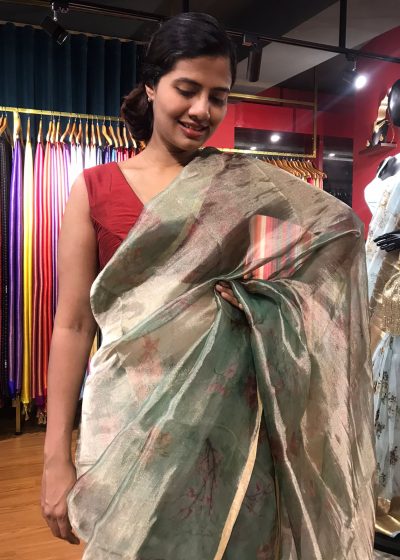 Sea Green Printed Tissue Silk Saree highlighted with Gold Piping