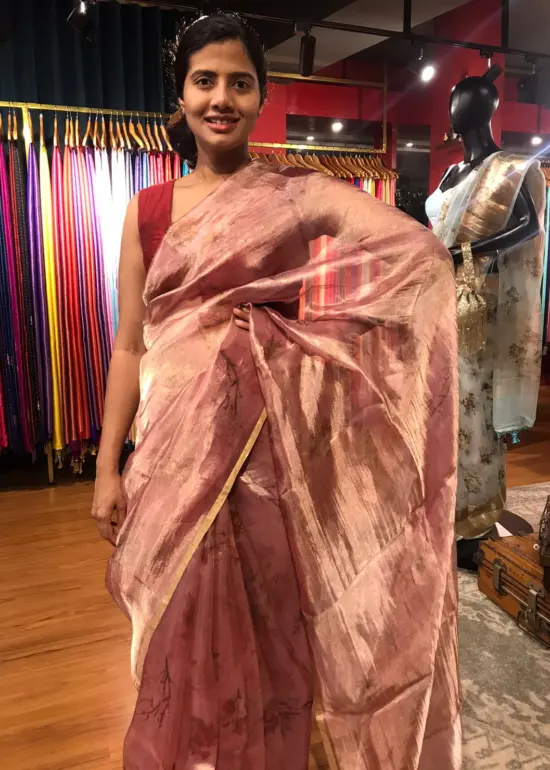 Blush Pink Printed Tissue Silk Saree highlighted with Gold Piping