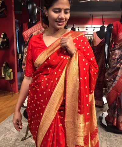 Red Crepe Silk Saree with Beautiful Gold Zari Buttas highlighted with Gold Woven Border