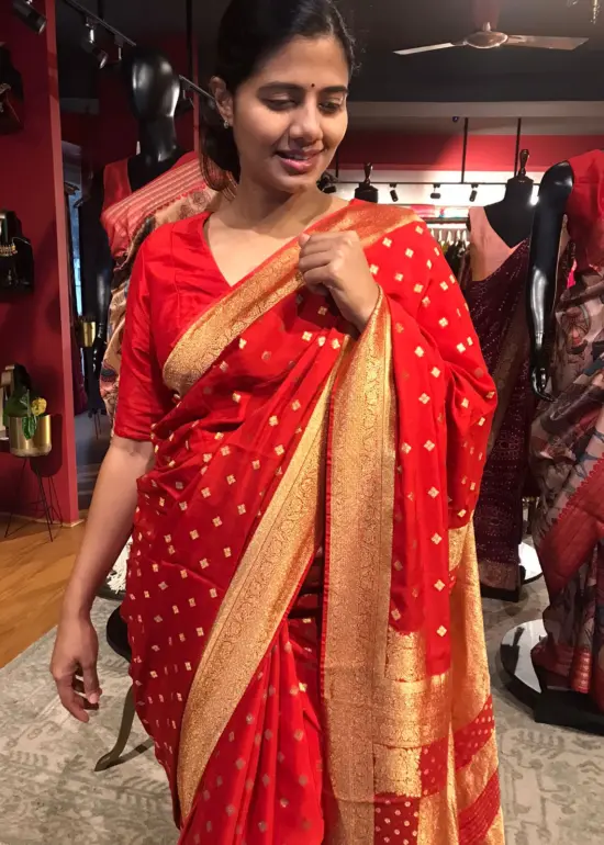 Red Crepe Silk Saree with Beautiful Gold Zari Buttas highlighted with Gold Woven Border