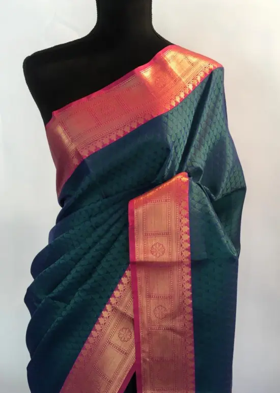 Peacock blue kora Silk Saree highlighted with zari weaves