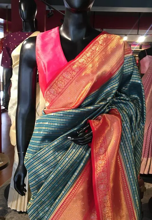 Aqua Blue Banarasi Silk Saree highlighted with gold and silver zari weaves