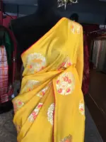 Yellow Dola Silk Saree Highlighted With Silver Zari Buttas