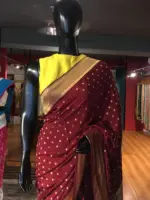 Maroon Crepe Silk Saree with Beautiful Gold Zari Buttas highlighted with Gold Woven Border