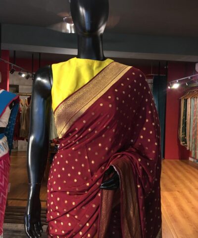Maroon Crepe Silk Saree with Beautiful Gold Zari Buttas highlighted with Gold Woven Border