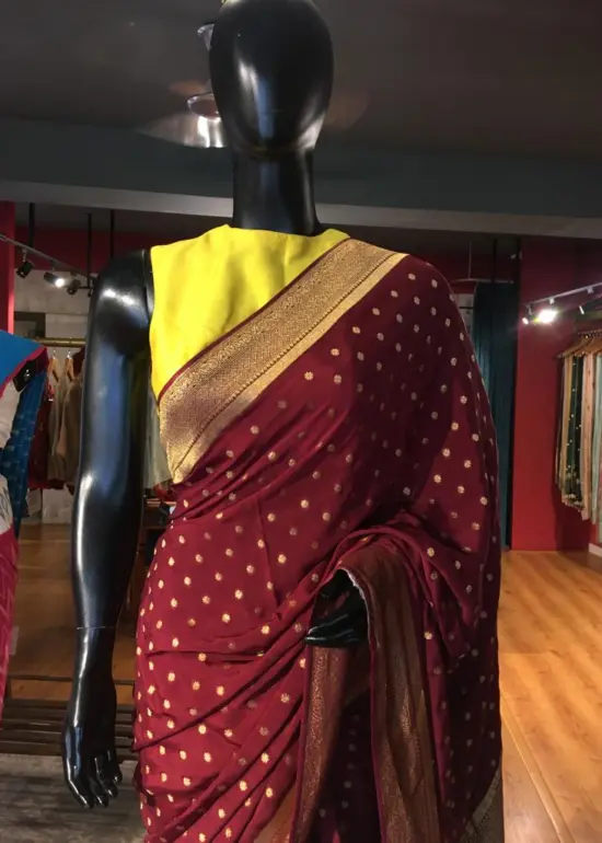 Maroon Crepe Silk Saree with Beautiful Gold Zari Buttas highlighted with Gold Woven Border