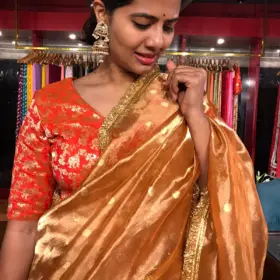 Orange Tissue Silk Saree woven with Beautiful Gold Zari Buttis