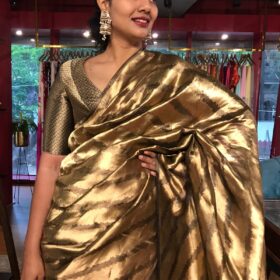 Molten Gold Tissue Silk Saree woven in Leheriya Pattern