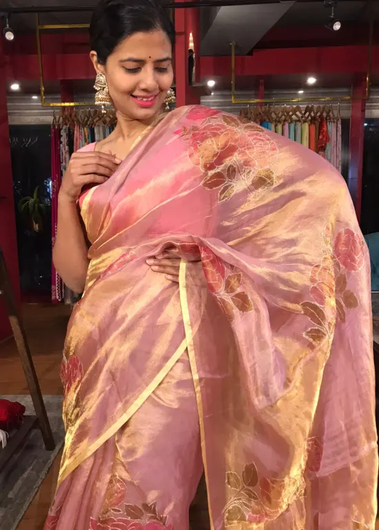 Nude Pink Tissue Silk Saree highlighted with Hand painted Florals and hand embroidery