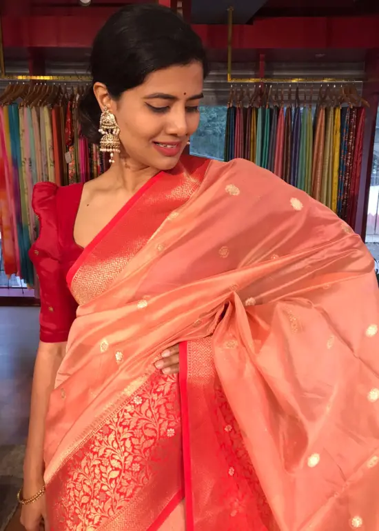 Peach Organza Saree with Contrast Zari Border and Gold Zari Buttis