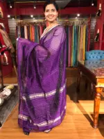 Side view of a model showcasing Purple Mangalagiri Silk Saree Handwoven in Chequered Pattern, Suitable for Puja Ceremonies By Mirra Clothing