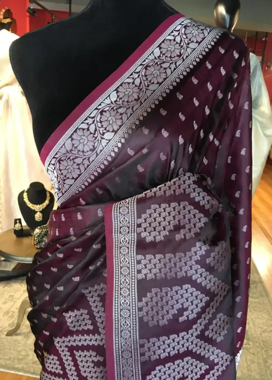 Maroon Banarasi Silk Saree highlighted with Silver Buttis