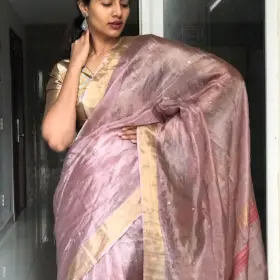 Onion Pink Tissue Silk Saree Embellished with Sequins highlighted with contrast Gold Zari Border