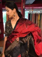 Arakku Red Kanchivaram Silk Saree with Readymade Intricate Embroidered Black Raw Silk Blouse