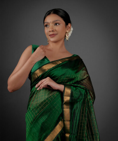 Front view of a model showcasing a Bottle Green Chequered Handwoven Mangalagiri Silk Saree, Suitable for Weddings & Receptions by Mirra Clothing