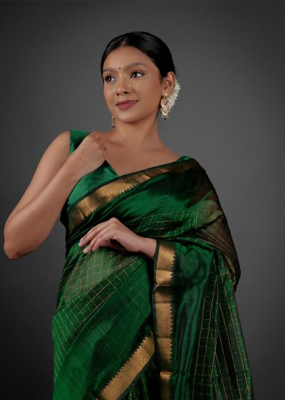 Front view of a model showcasing a Bottle Green Chequered Handwoven Mangalagiri Silk Saree, Suitable for Weddings & Receptions by Mirra Clothing