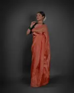 Side view of a model showcasing Orange Tissue Silk Saree , Ideal for festive occasions By Mirra Clothing