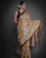 Side view of a model showcasing Yellow Kalamkari Printed Mangalagiri Silk Saree, Suitable For Religious Ceremonies By Mirra Clothing