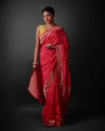 Front view of a model showcasing a Rani Pink Banarasi Georgette Saree With Gold Zari weaves , Elegant attire for religious rituals and ceremonies By Mirra Clothing