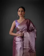 "Elegant lavender tissue silk saree featuring intricate zari weaves and delicate patterns."By Mirra Clothing