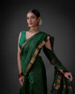 A model wearing a Bottle Green Mangalagiri silk saree by Mirra Clothing