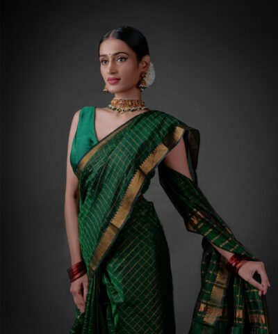 A model wearing a Bottle Green Mangalagiri silk saree by Mirra Clothing