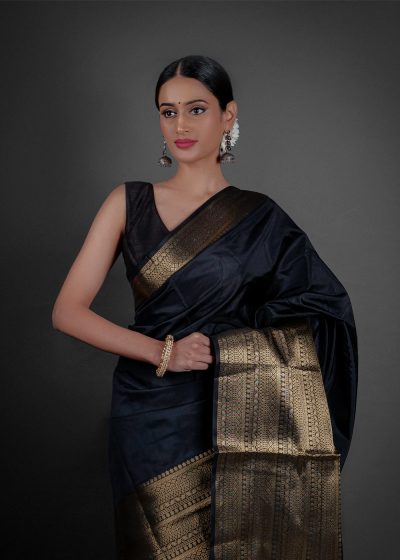 "A luxurious Banarasi saree in deep gold, adorned with intricate zari work and traditional perfect for festive occasions."by Mirra Clothing