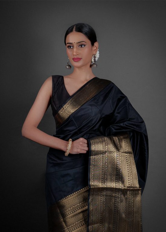 "A luxurious Banarasi saree in deep gold, adorned with intricate zari work and traditional perfect for festive occasions."by Mirra Clothing