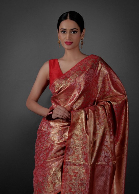 Close up view of a model showcasing Red Banarasi Silk Saree with Gold Zari Weaves , Suitable for Festive occasions By Mirra Clothing