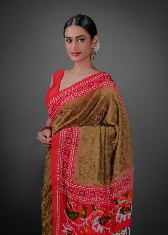 Close up view of a model showcasing Moss Green Printed Georgette Saree with Chikankari Weaves , Suitable for dance performances or cultural festivals By Mirra Clothing