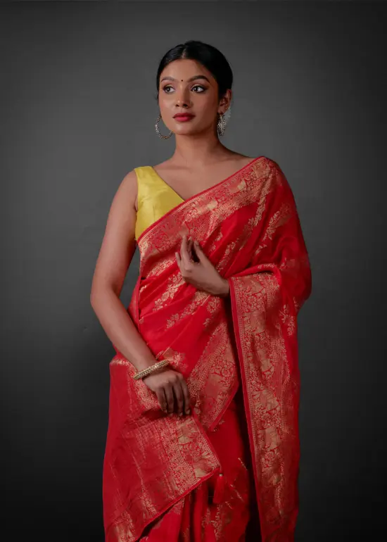 Front view of a model showcasing a Rani Pink Banarasi Georgette Saree With Gold Zari weaves , Perfect for birthdays or anniversaries within the family