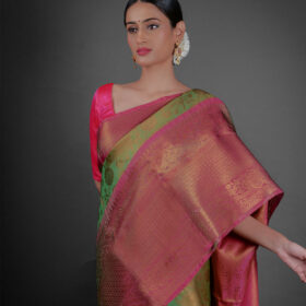 Close up view of a model showcasing Green Tissue Silk Saree With Contrast Border , Ideal for festivities By Mirra Clothing