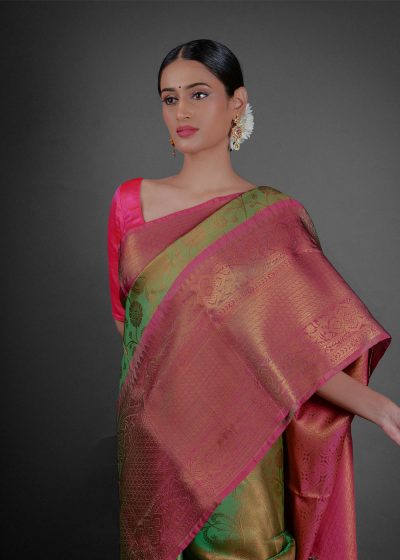Close up view of a model showcasing Green Tissue Silk Saree With Contrast Border , Ideal for festivities By Mirra Clothing
