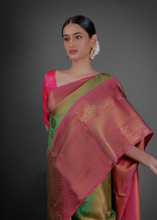 Close up view of a model showcasing Green Tissue Silk Saree With Contrast Border , Ideal for festivities By Mirra Clothing
