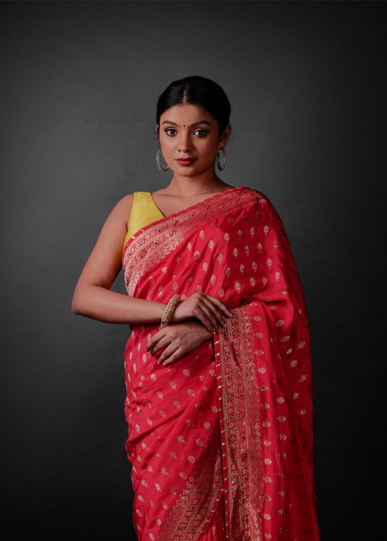 Close up view of a model showcasing Rani Pink Banarasi Georgette Saree With Gold Zari weaves , Perfect for birthdays or anniversaries within the family By Mirra Clothing