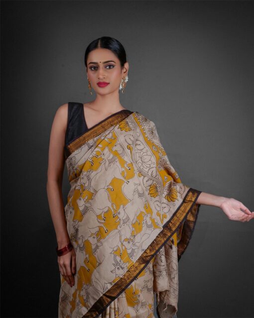 Close up view of a model showcasing Yellow Kalamkari Printed Mangalagiri Silk Saree, perfect for cultural events By Mirra Clothing