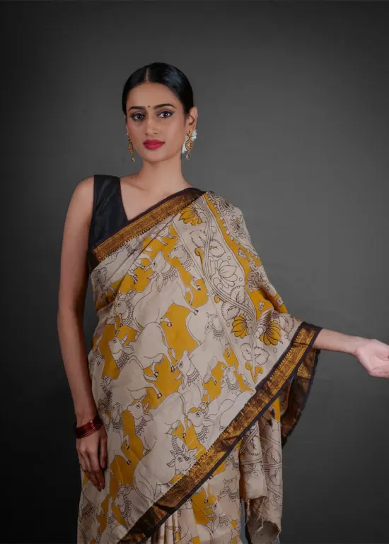 Close up view of a model showcasing Yellow Kalamkari Printed Mangalagiri Silk Saree, perfect for cultural events By Mirra Clothing