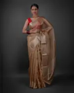 Full view of a model showcasing Ivory Tissue Silk Saree with Gold Zari Stripes, Adds a touch of sophistication to evening gatherings By Mirra Clothing