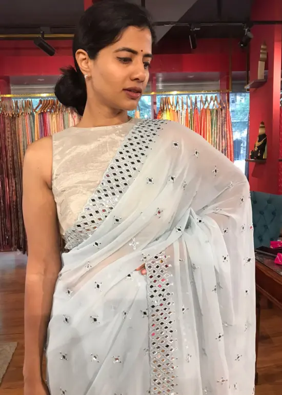 Front view of a model showcasing a Baby Blue Chiffon Silk Saree Embellished with Mirrors, An Excellent Option for Party Outfits By Mirra Clothing