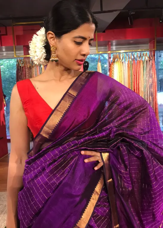Close up view of a model showcasing Purple Mangalagiri Silk Saree Handwoven in Gold Zari Chequered Pattern, Suitable for Traditional Photoshoots & Cultural Exhibitions By Mirra Clothing