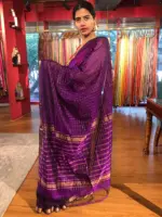 Side view of a model showcasing Purple Mangalagiri Silk Saree Handwoven in Gold Zari Chequered Pattern, Suitable for Religious Ceremonies & Pujas By Mirra Clothing