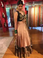 Side view of a model showcasing Dusty Pink Half Saree Silk Lehenga Set, Suitable for Festive wear By Mirra Clothing