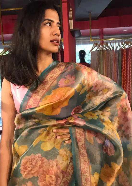 Close up view of a model showcasing Blue Printed Tissue Silk Saree, Suitable for traditional performances or fairs By Mirra Clothing