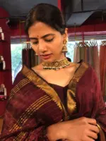 Close up view of a model showcasing Brown Mangalagiri Silk Saree woven in Gold Zari Checks, Suitable for Traditional Photoshoots by Mirra Clothing