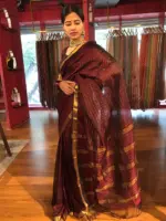 Side view of a model showcasing Brown Mangalagiri Silk Saree woven in Gold Zari Checks, Suitable for Religious Ceremonies & Pujas by Mirra Clothing