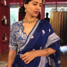 Close up view of a model showcasing Blue Khaddi Banarasi Chiffon Silk Saree with Kadwa Zari Motifs, Suitable for festive occasions By Mirra Clothing